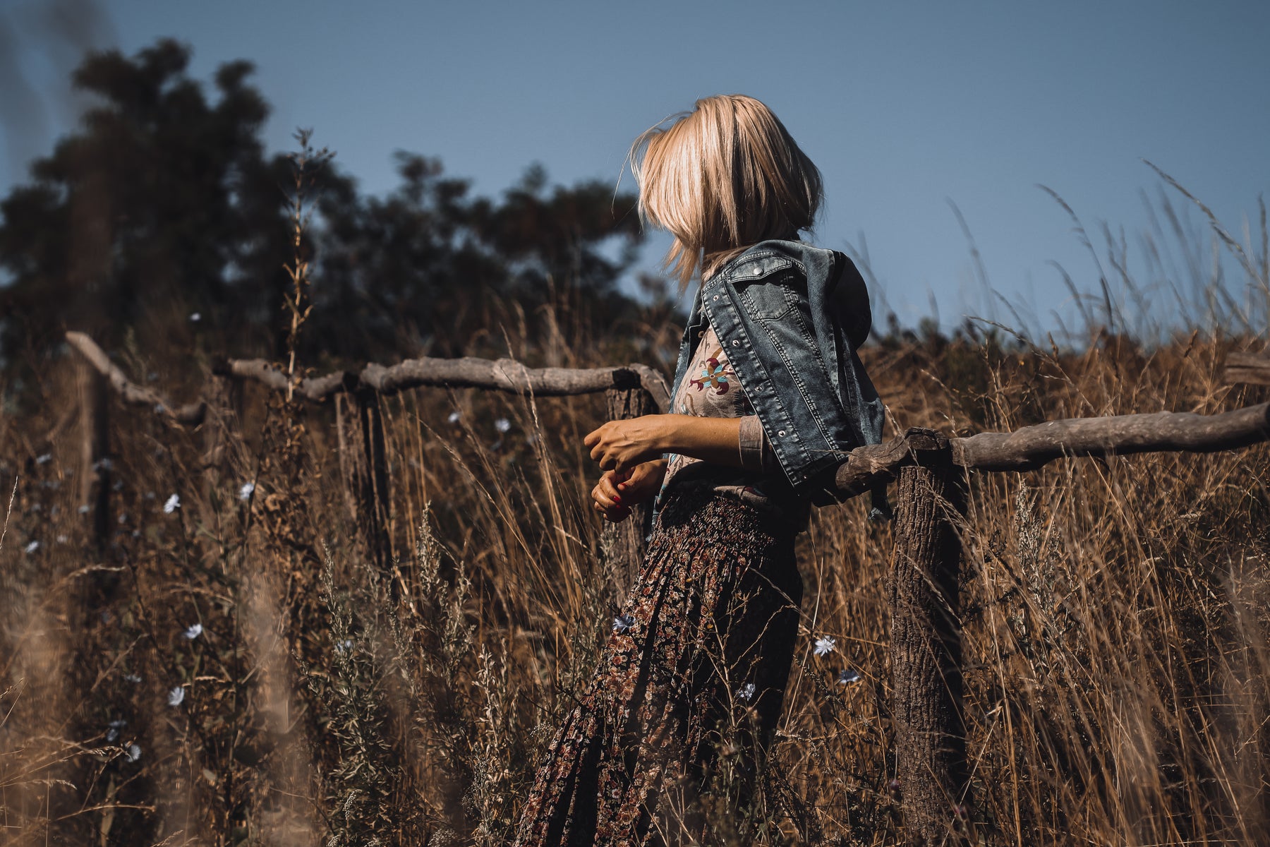 Nach der Bearbeitung mit einem Woodland-Folklore-Preset: stimmungsvolles Outdoorporträt mit tiefen Erdtönen und zurückgenommenem Himmel